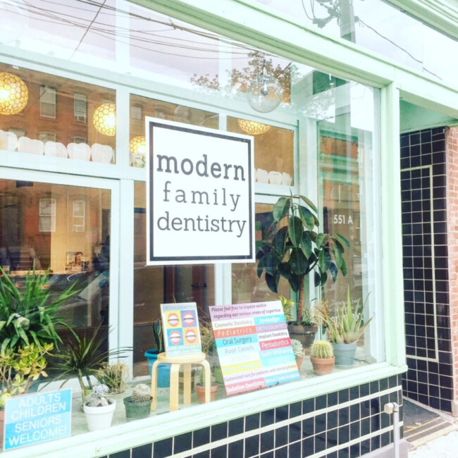 Exterior of Modern Family Dentistry office with plants in the window