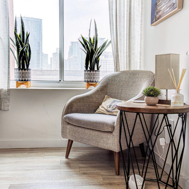 Room with natural light in Anchor Therapy office with a chair, side table, and large window