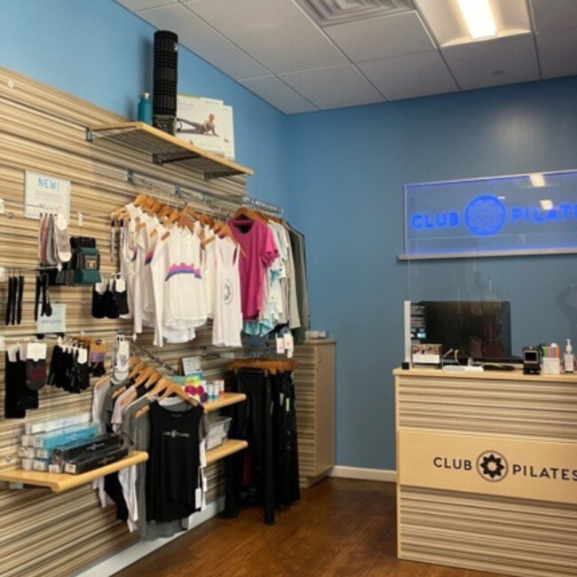 Club Pilates entrance with desk and wall of clothing and merchandise