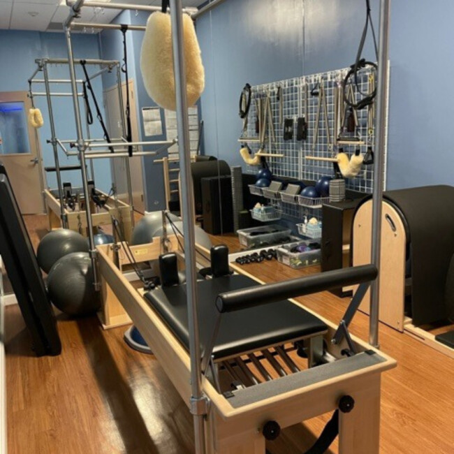 Reformers, balls, and a wall of equipment at Club Pilates