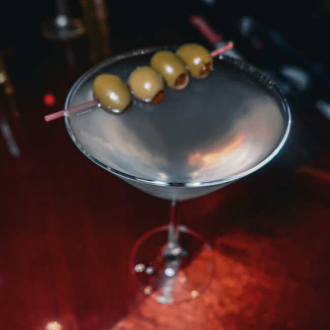 A martini with four olives