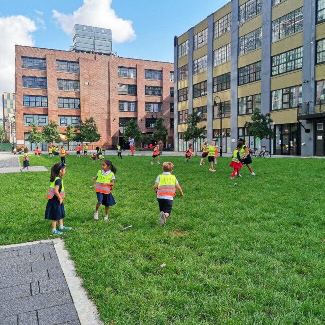 A group of students outside playing in a field