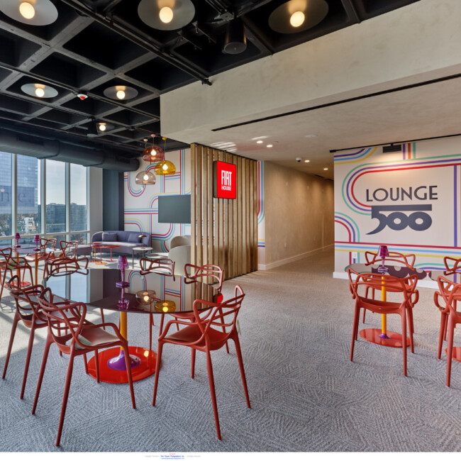 Lounge 500 in Fiat House with tables and red chairs