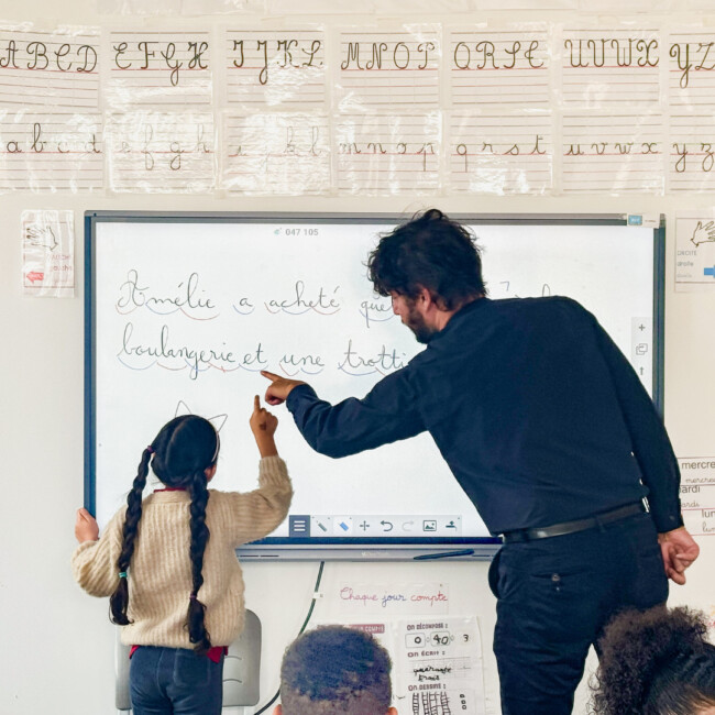 A student and a teacher looking at the board together