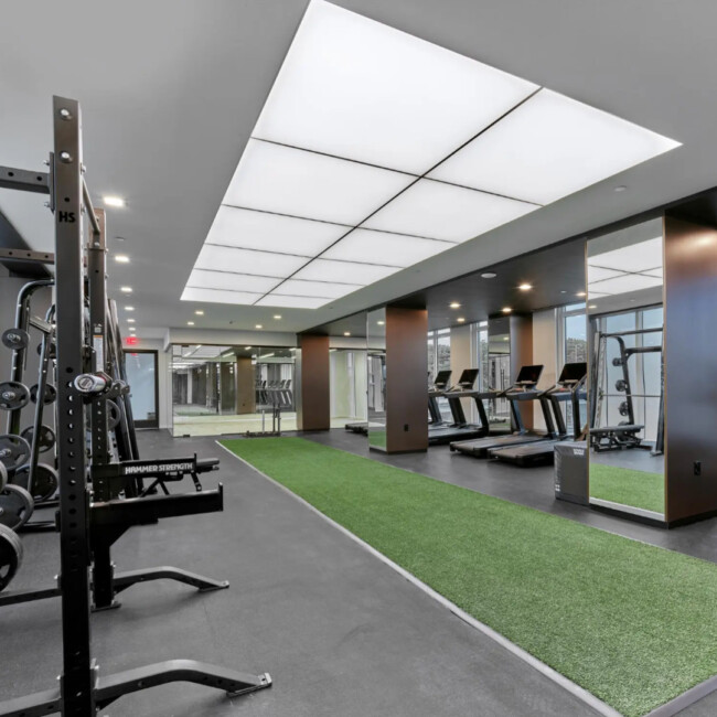 Gym with weight rack and treadmills in Fiat House